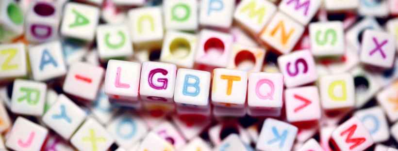 LGBTQ written on dice